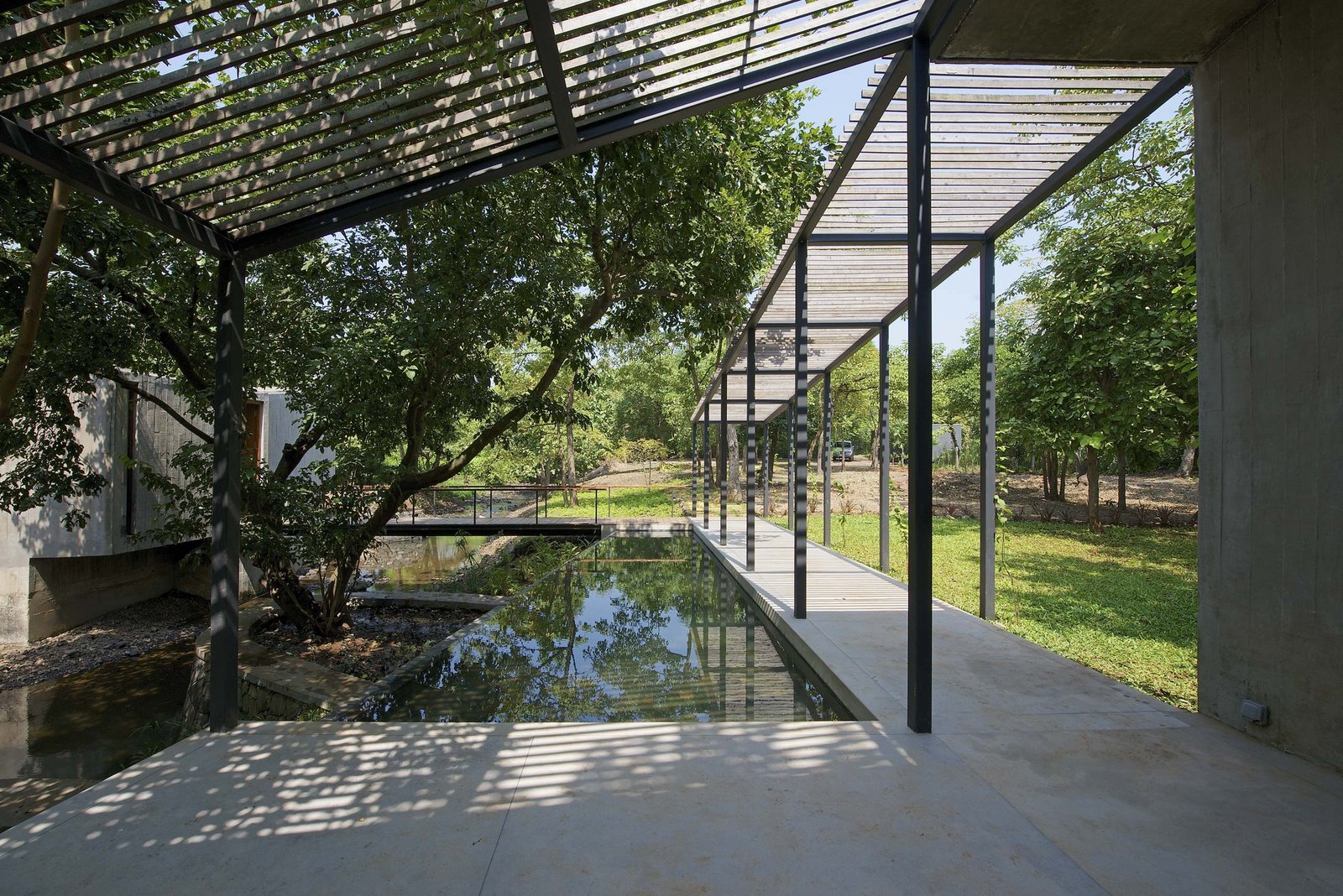 pool and entrance pavilion house on a stream by architecture firm in Mumbai