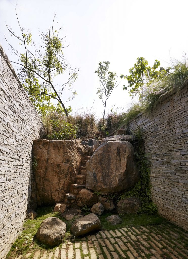 Riparian House nature rock carved courtyard wall